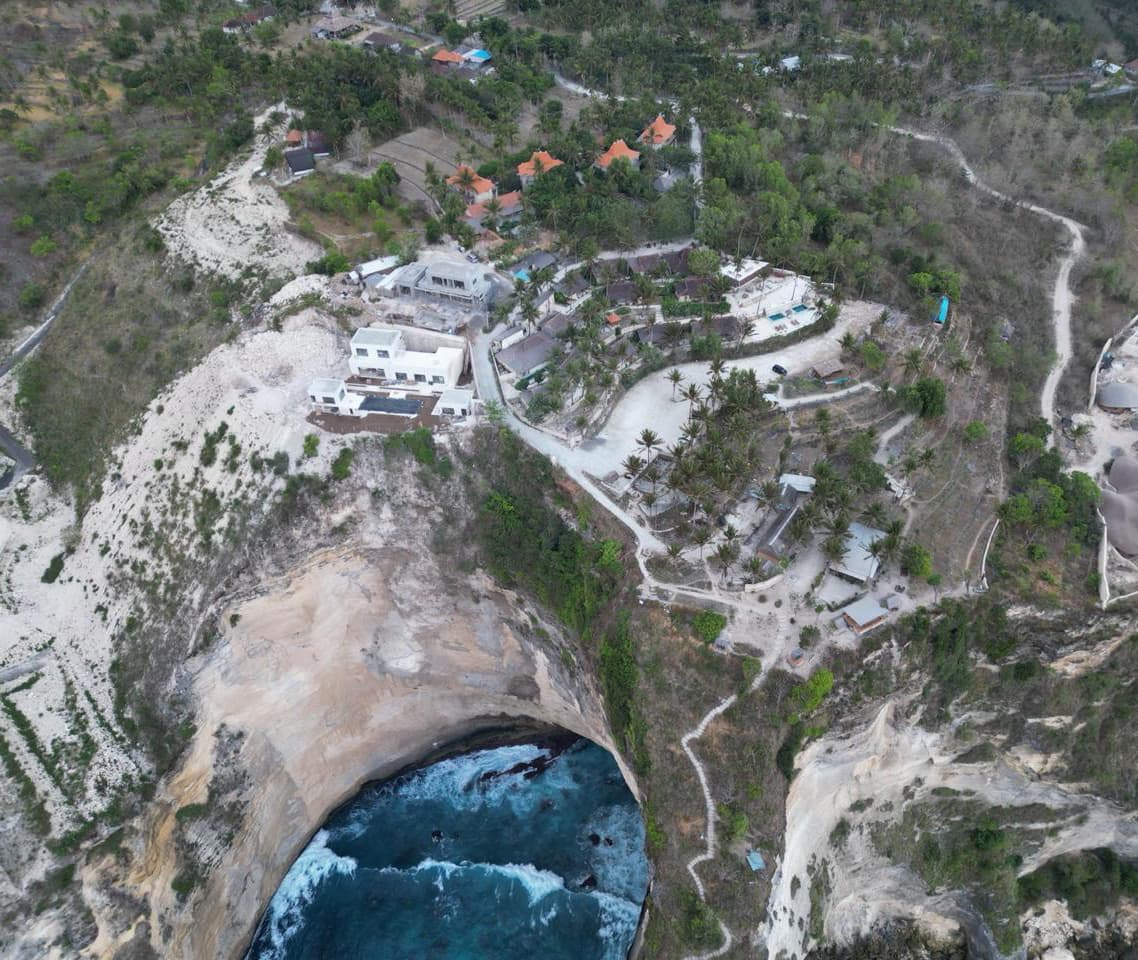 Aerial view of a cliff and turquoise cove on Nusa Penida island, Indonesia
